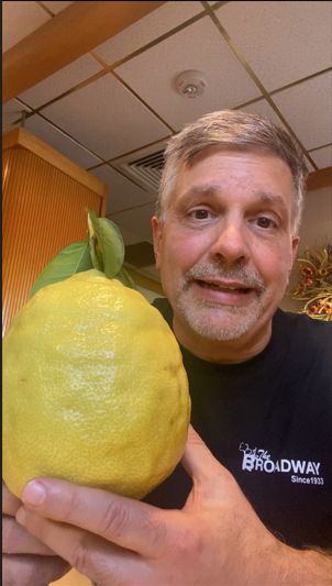 Owner of Logee's Greenhouse holding the giant Pomodoro lemon