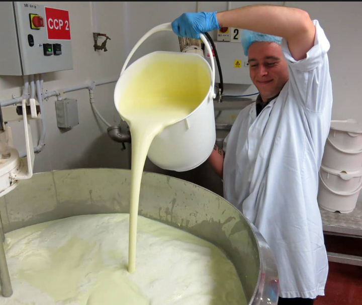 Worker pouring cream into mixer at The Broadway