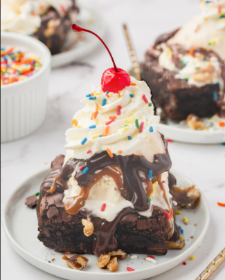 Brownie sundae with whipped cream and cherry
